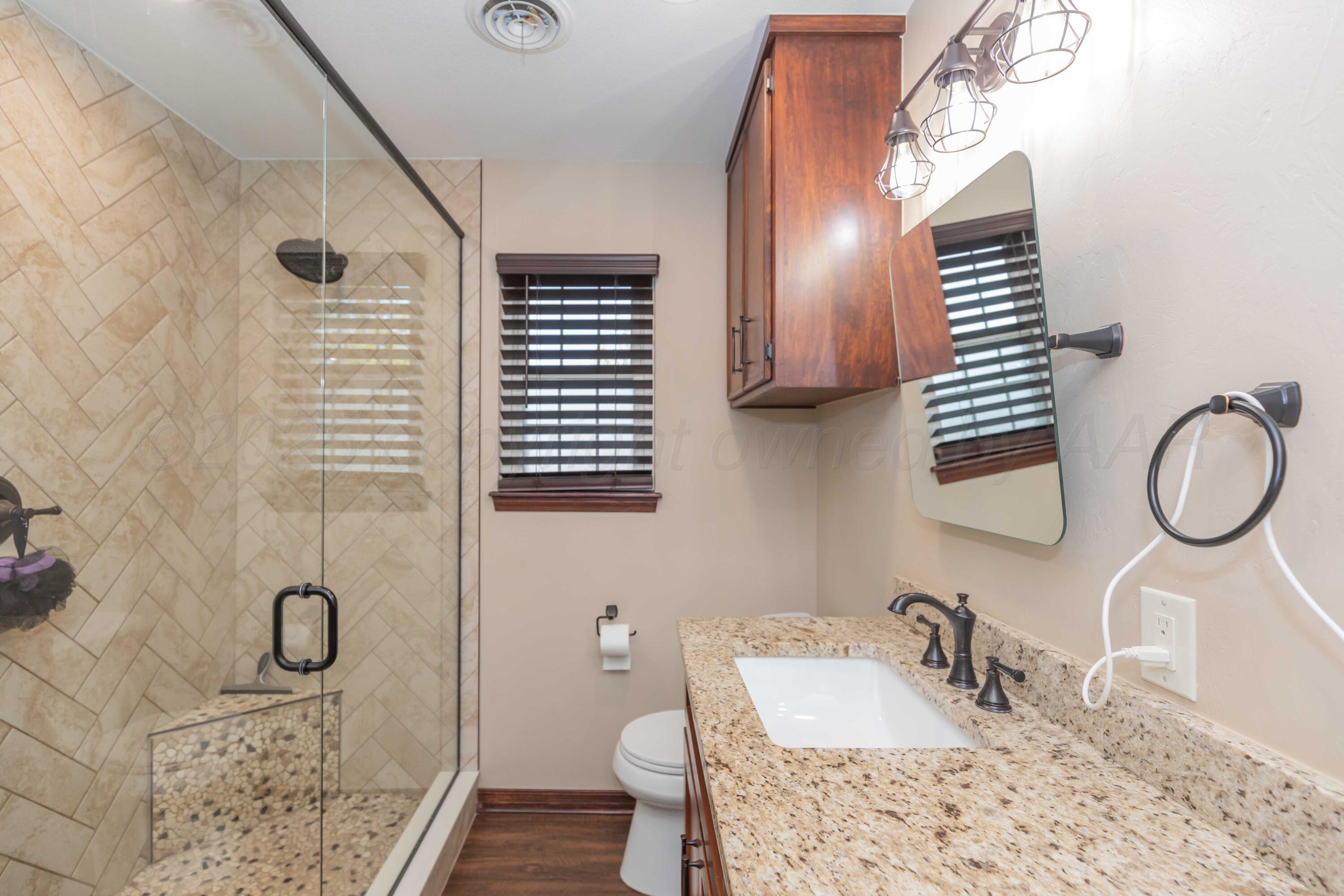 199 County Road BB Groom, TX 79039 - Photo 23 of 39 a bathroom with a granite countertop sink and a mirror