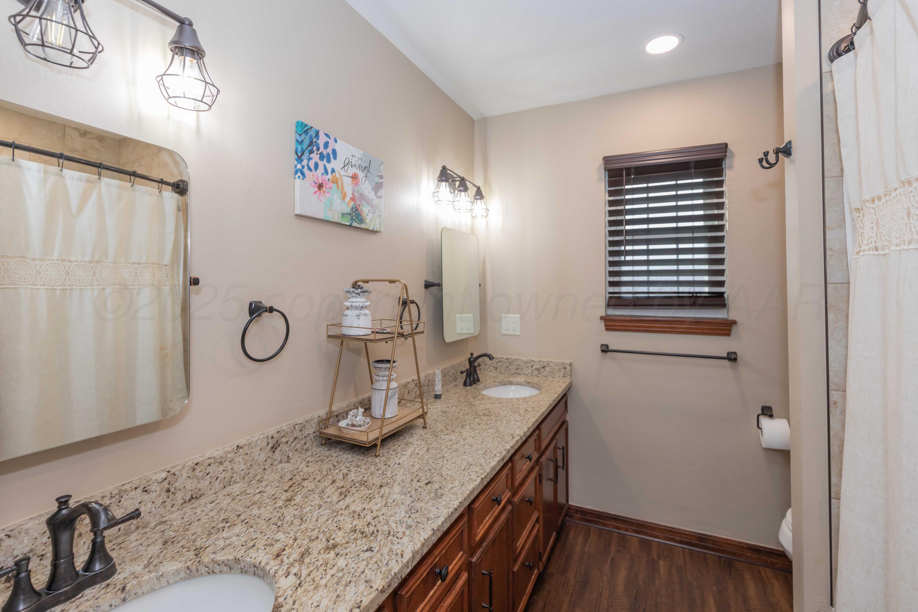 199 County Road BB Groom, TX 79039 - Photo 26 of 39 a bathroom with a granite countertop sink and a mirror
