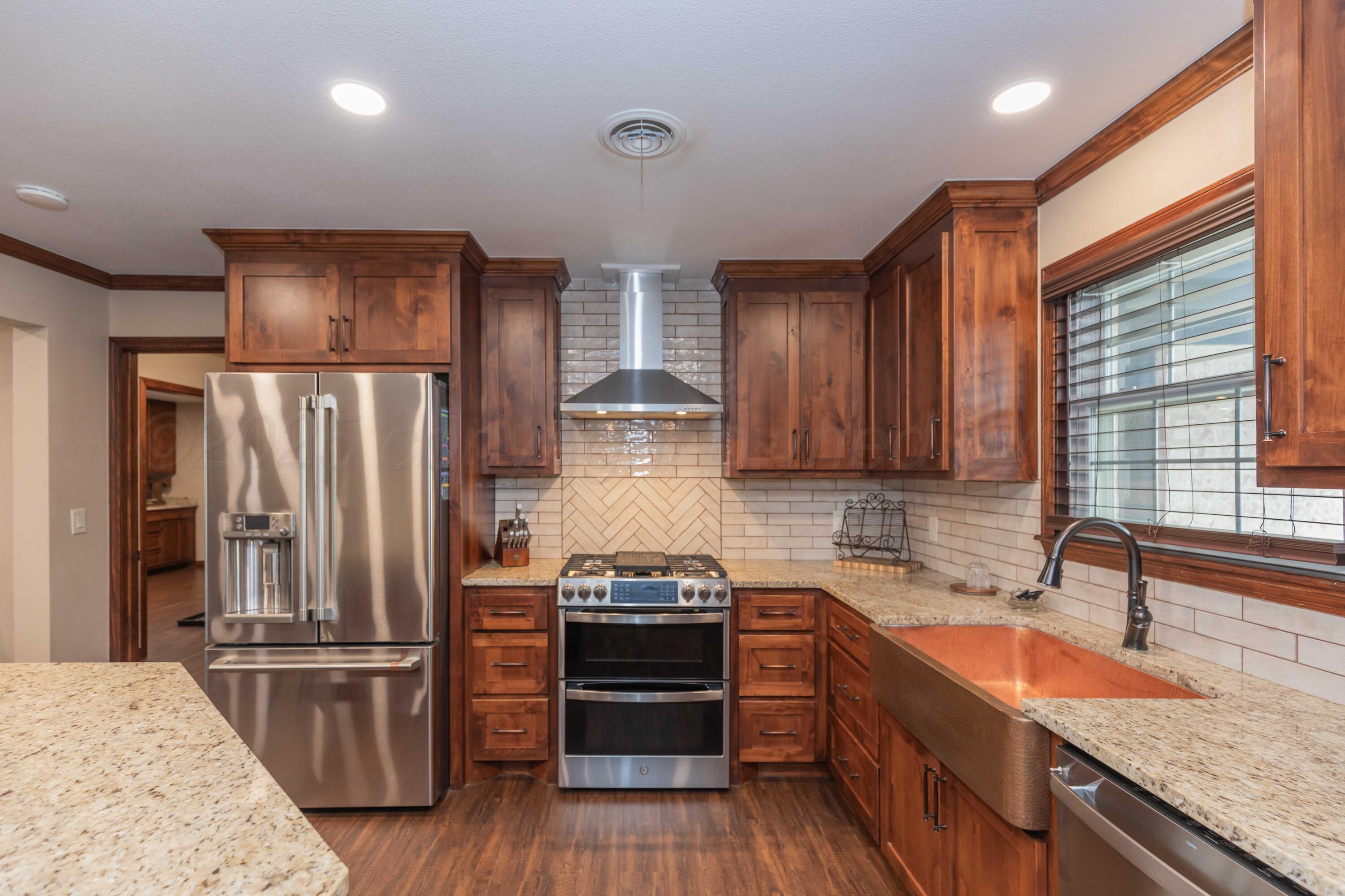 199 County Road BB Groom, TX 79039 - Photo 9 of 39 a kitchen with stainless steel appliances granite countertop a refrigerator stove and sink