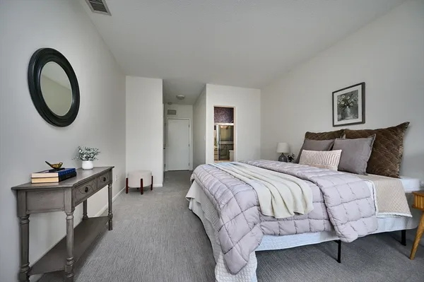 a bedroom with a bed and a dresser