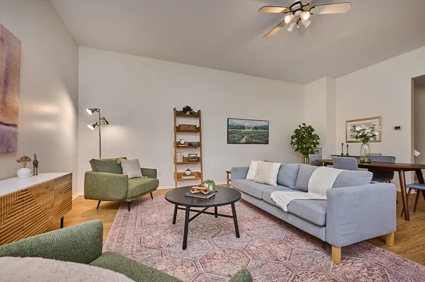 a living room with furniture and a chandelier