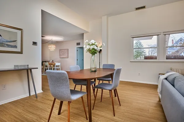 a view of a dining room with furniture and wooden floor