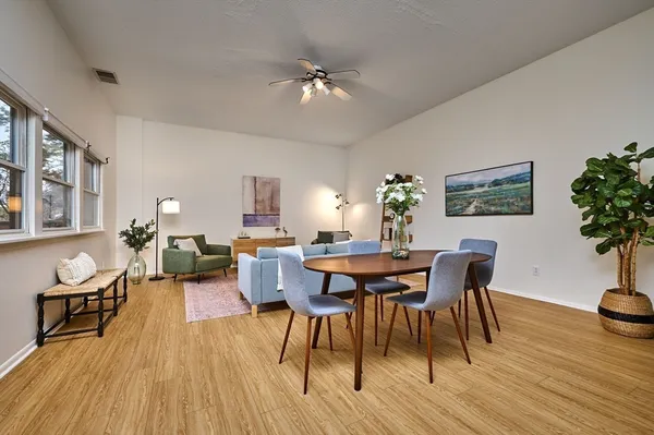 a view of a dining room with furniture and wooden floor