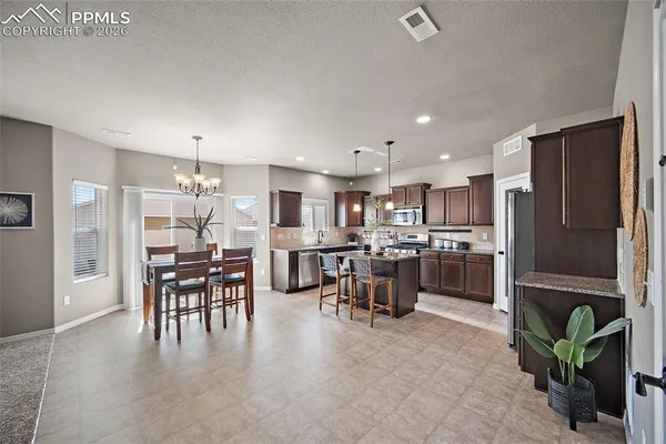 a kitchen with a table and chairs