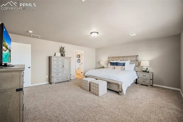 a bed room with a bed and a chair
