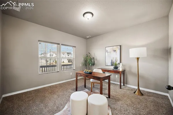a dining room with furniture and window