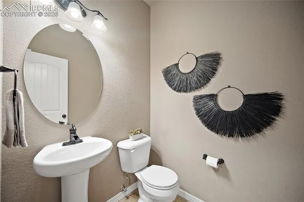 a bathroom with a sink a mirror and toilet and mirror