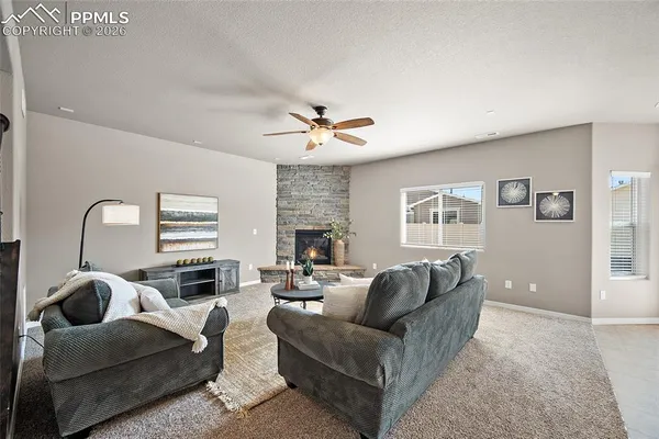 a living room with furniture a fireplace and a flat screen tv