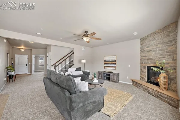 a living room with furniture and a fireplace