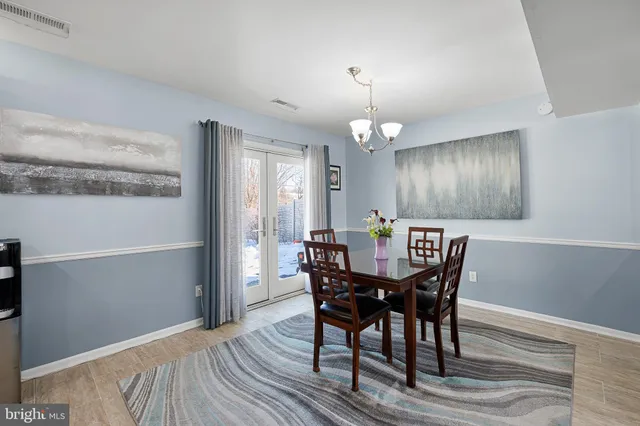 a view of a dining room with furniture and chandelier