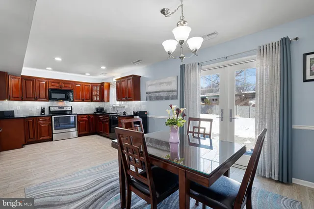 a view of a dining room with furniture large window and wooden floor