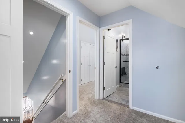 a view of a hallway with closet and wooden floor