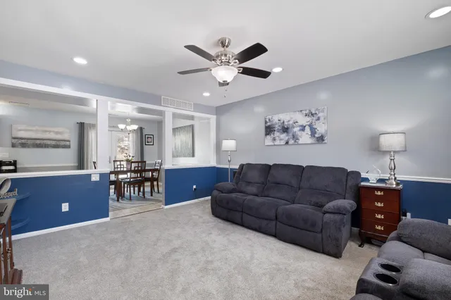a living room with furniture and kitchen view