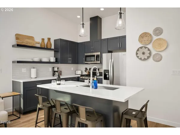 a kitchen with stainless steel appliances a sink stove and refrigerator