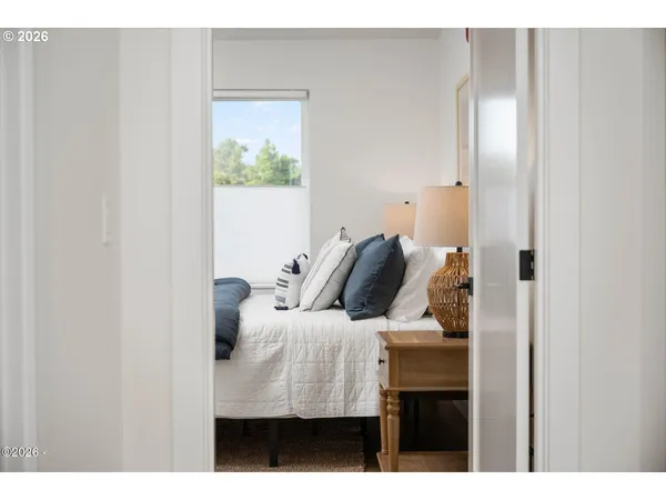 a bedroom with a bed and a window