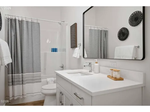 a bathroom with a sink vanity mirror and toilet