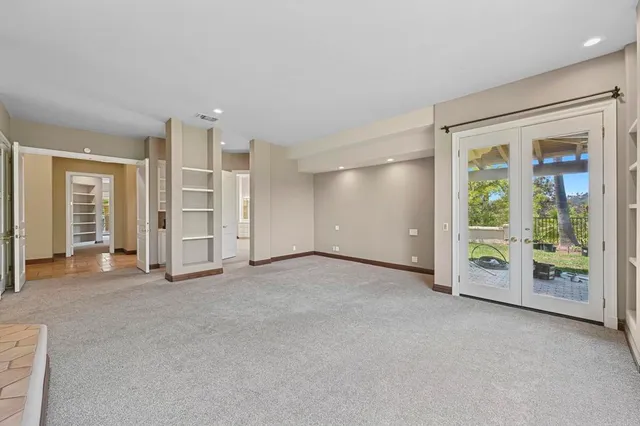 an empty room with closet and windows