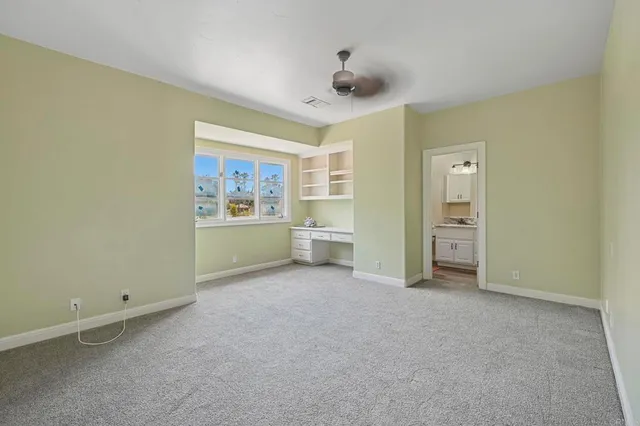 a bathroom with a granite countertop sink a toilet and shower