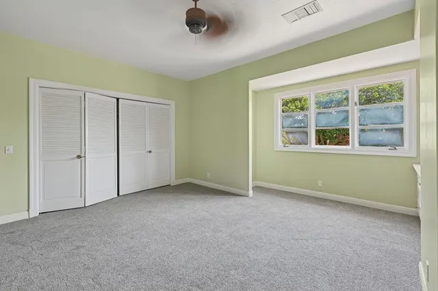 a bathroom with a granite countertop sink a toilet and shower