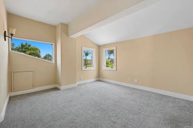 an empty room with windows lake and mountain view