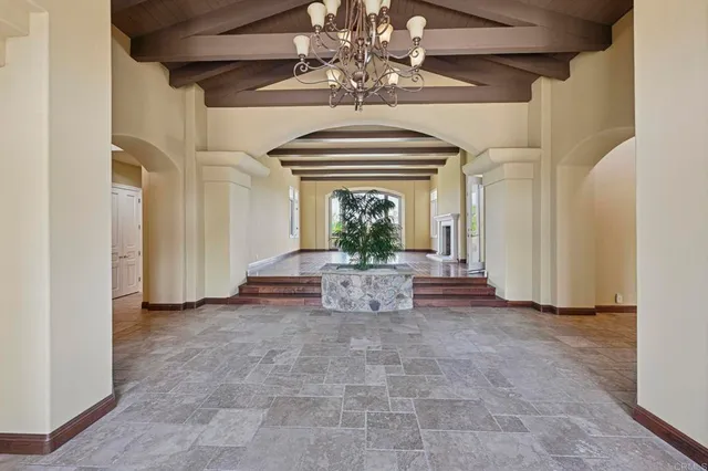 a living room with fireplace furniture flat screen tv and wooden floor