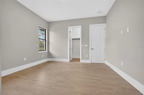 a bathroom with a granite countertop toilet a sink and a mirror