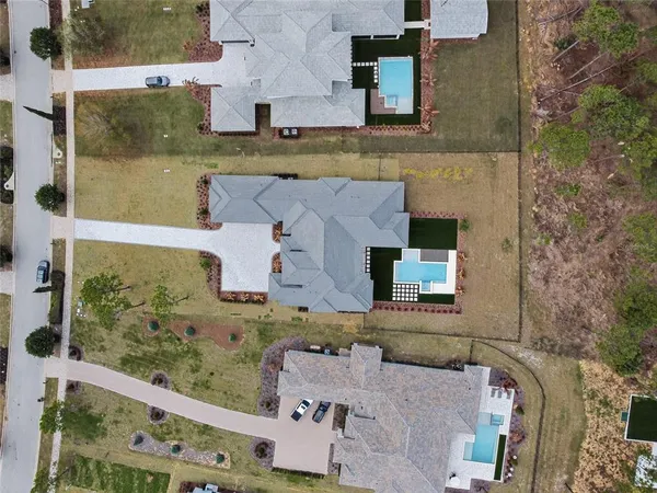 an aerial view of a house with a yard