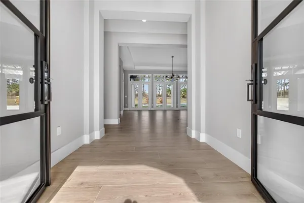 a view of empty room with wooden floor and fireplace