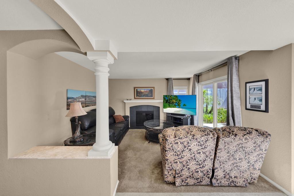 3761 Hillview Way Oceanside, CA 92056 - Photo 31 of 75 a living room with furniture a flat screen tv and a fireplace