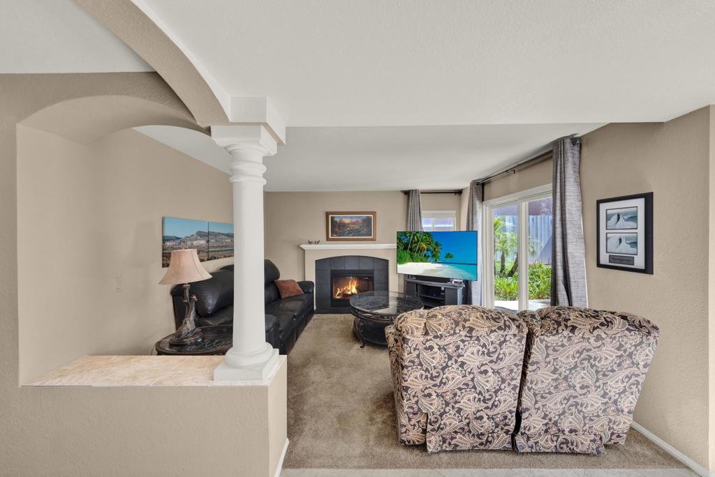 3761 Hillview Way Oceanside, CA 92056 - Photo 32 of 75 a living room with furniture a fireplace and a flat screen tv