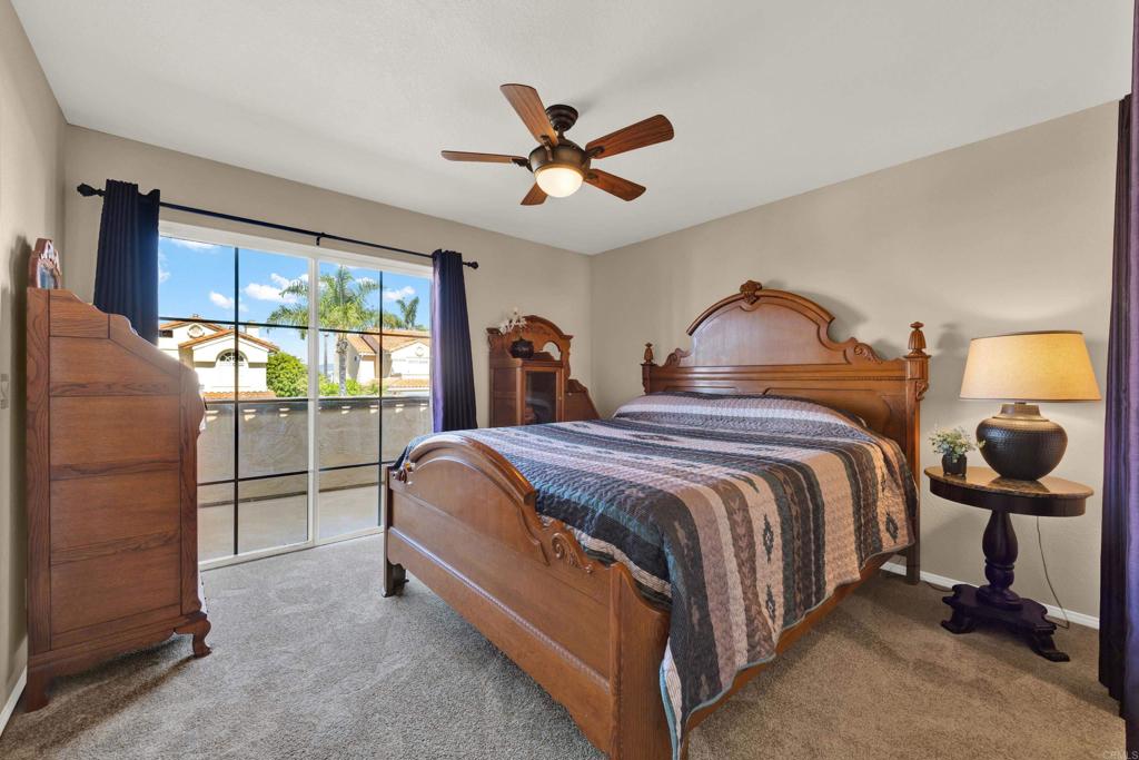 3761 Hillview Way Oceanside, CA 92056 - Photo 58 of 75 a spacious bedroom with a bed and a chandelier