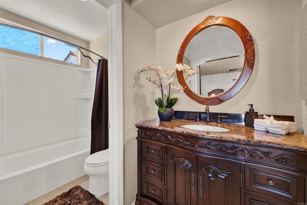 3761 Hillview Way Oceanside, CA 92056 - Photo 62 of 75 a bathroom with a granite countertop sink vanity mirror bathtub and toilet