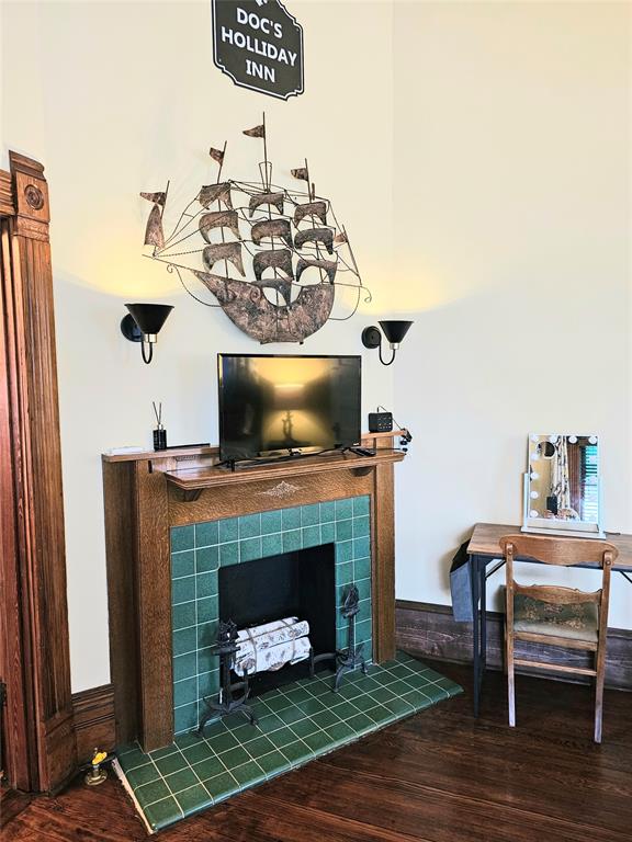 1111 West Main Street Denison, TX 75020 - Photo 17 of 36 a living room with furniture a flat screen tv and a fireplace
