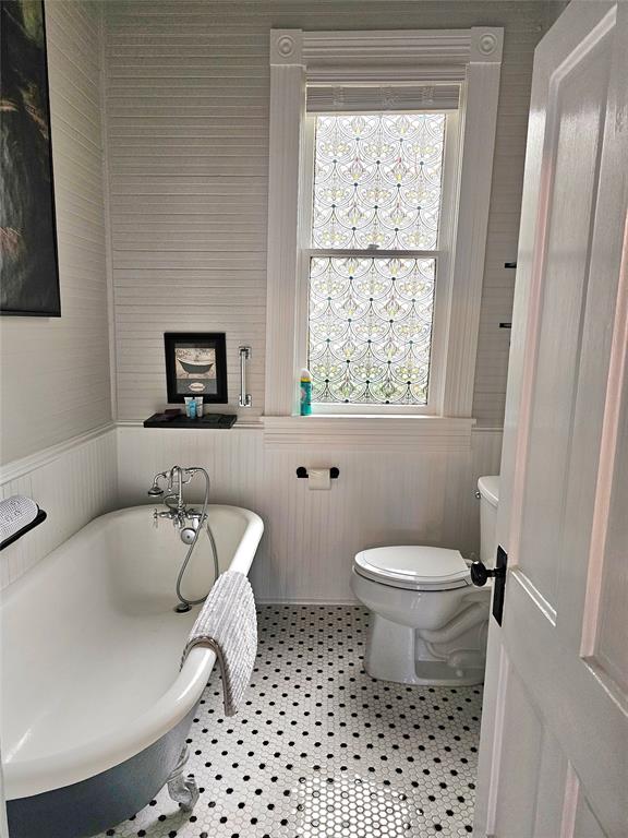 1111 West Main Street Denison, TX 75020 - Photo 19 of 36 a bathroom with a toilet a sink and a window