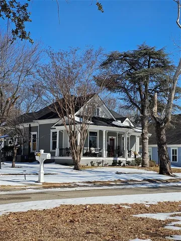 a living room with furniture a fireplace and a table