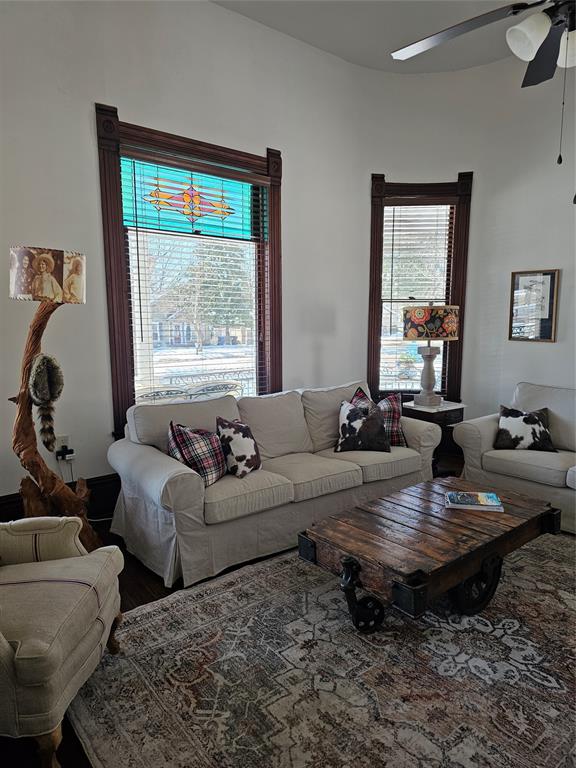 1111 West Main Street Denison, TX 75020 - Photo 35 of 36 a living room with couches a coffee table and a window with potted plants