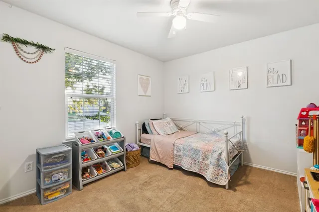 a bedroom with bed and a window