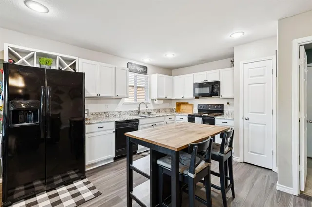 a kitchen with a refrigerator a stove top oven a sink dishwasher and a refrigerator