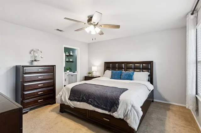 a bedroom with a bed and ceiling fan