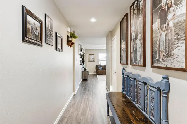 a view of hallway with wooden floor