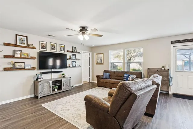 a living room with furniture and a flat screen tv