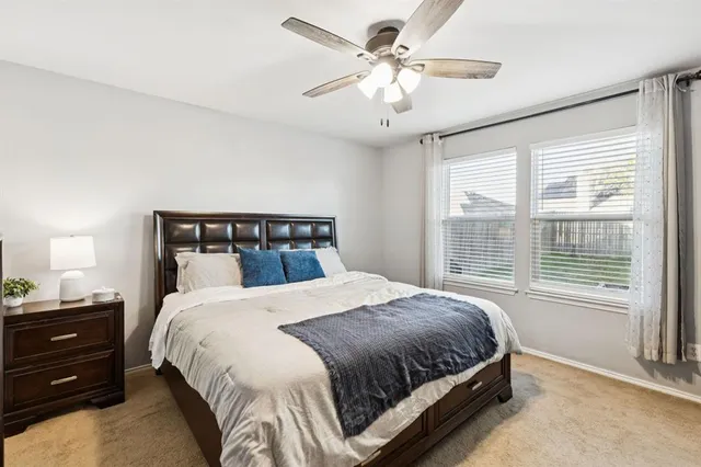 a bedroom with a large bed and a window