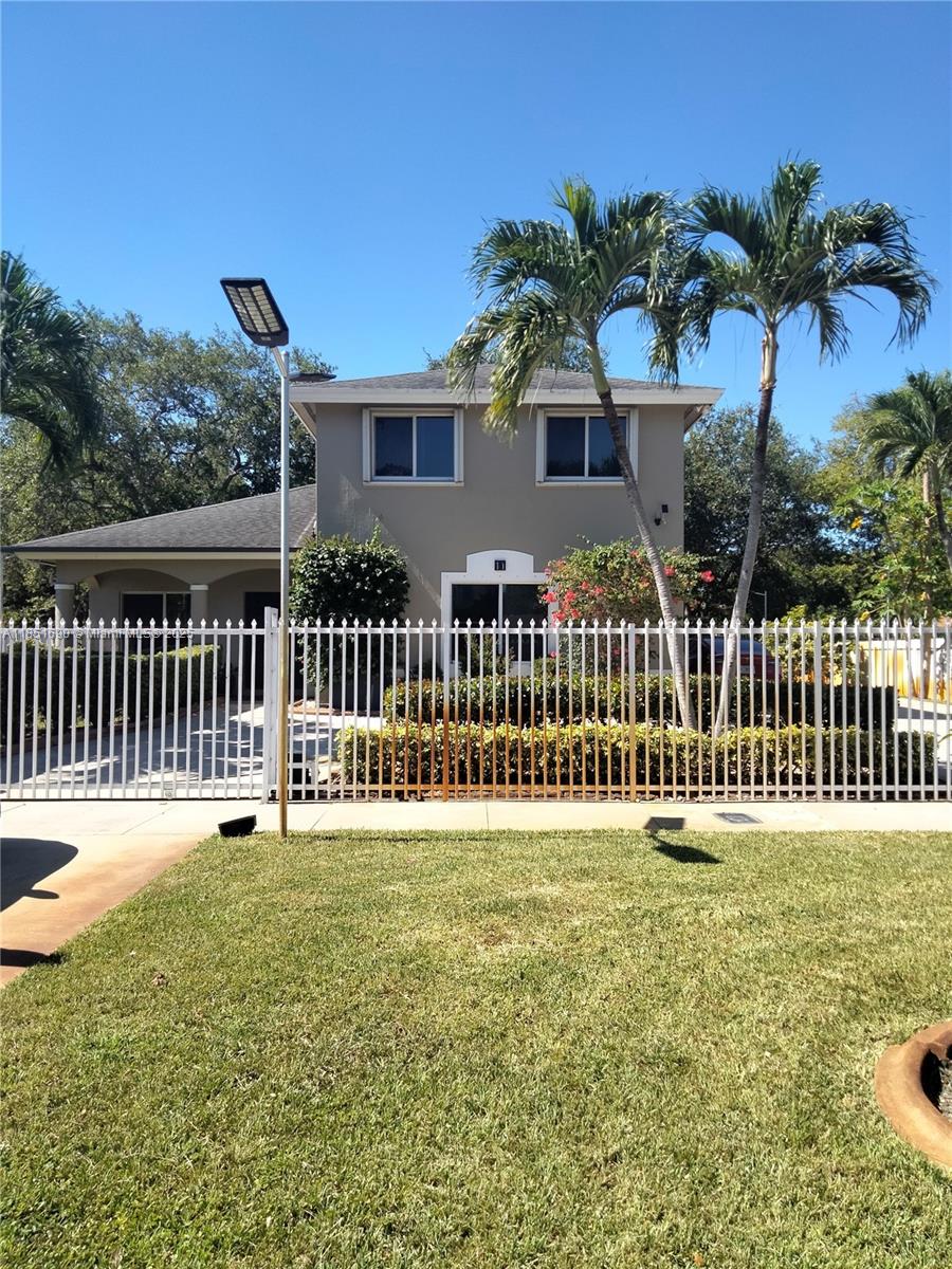 a view of a house with a yard and a garden