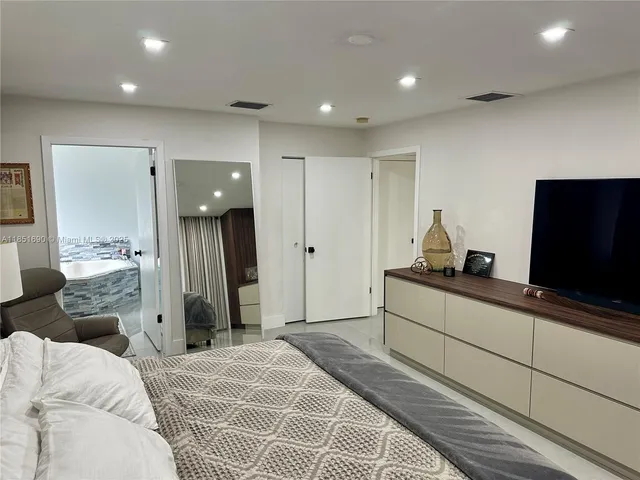 a bathroom with double vanity and a bathtub