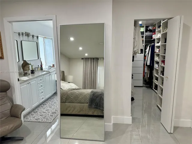 a view of a hallway with wooden floor and entryway