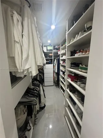 a view of a hallway with wooden floor and closet