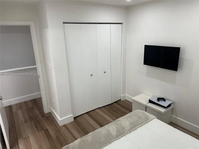 a bathroom with a sink a toilet a mirror and shower