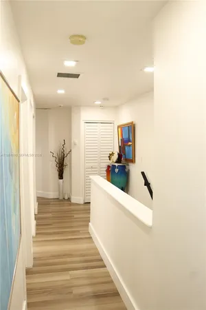 a view of a backyard with table and chairs potted plants and large tree
