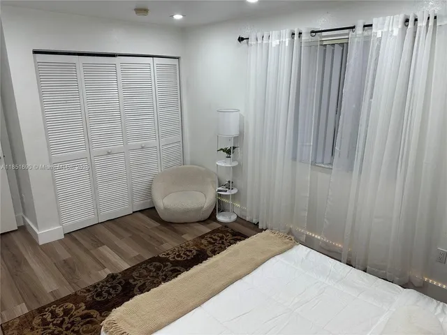 a view of a backyard with a garden and trees