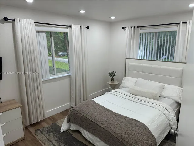 a view of a house with backyard and a sitting area